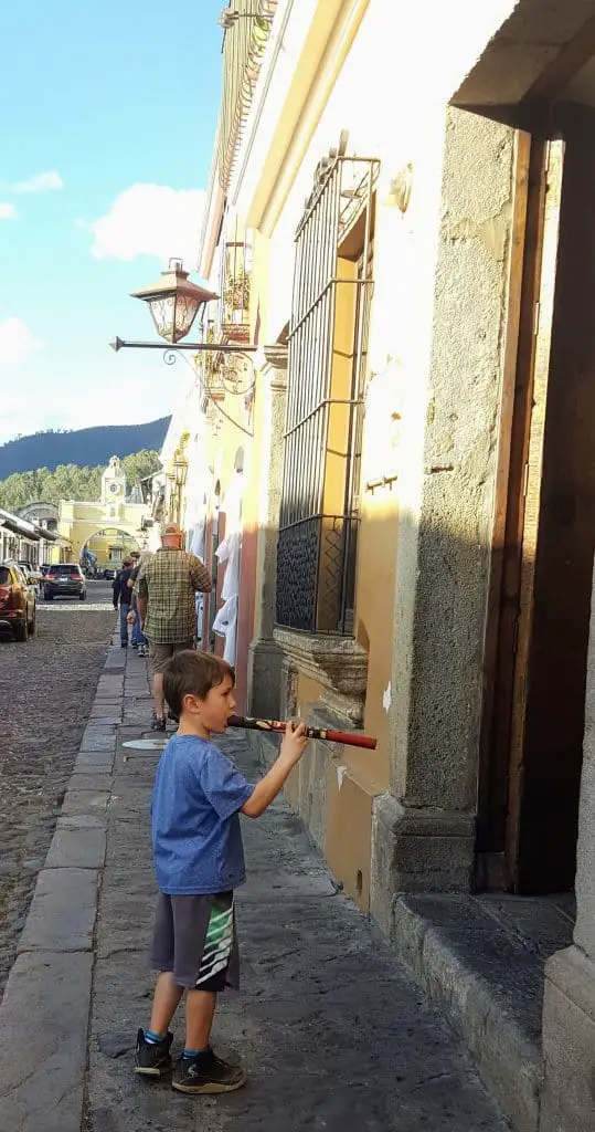 Eli playing his new flute with Arco de Santa Catalina in the background