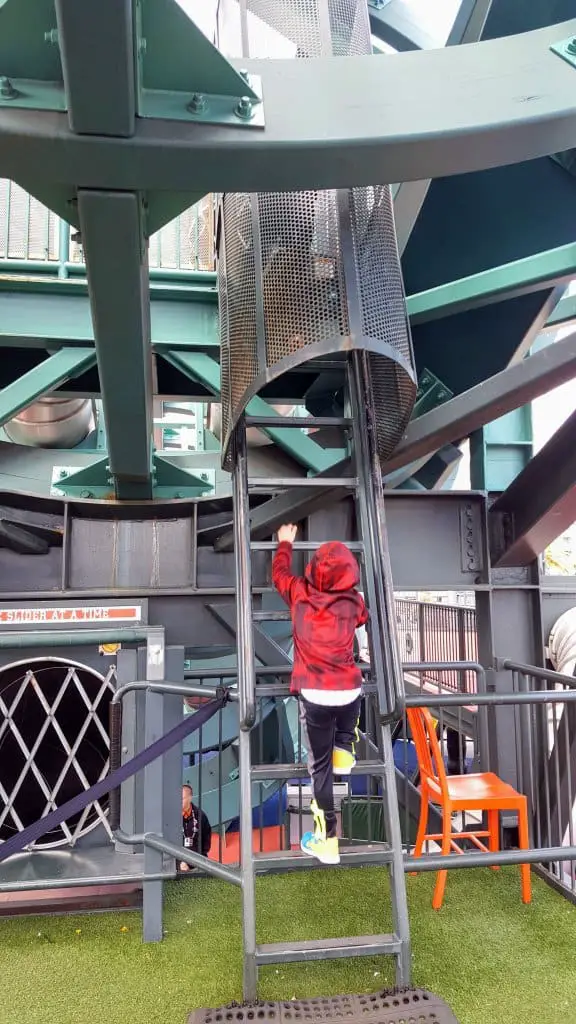 Eli climbing the ladder to the top of the slide inside the coke bottle at Oracle Park Baseball field San Francisco