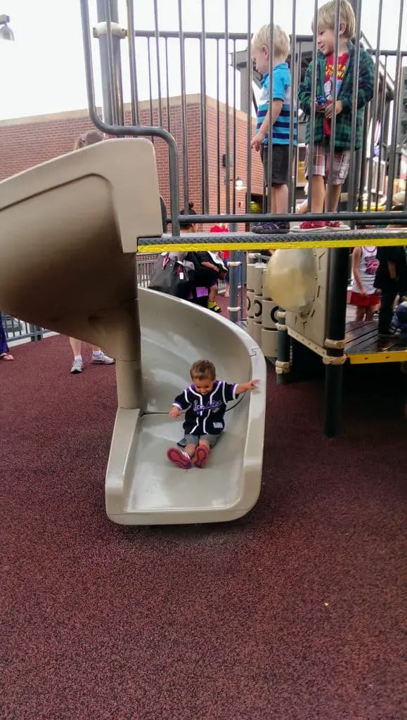 Eli on a slide at Dinger's Playground at Coors Field