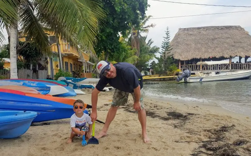 Father and son on the beach in Placencia, Belize