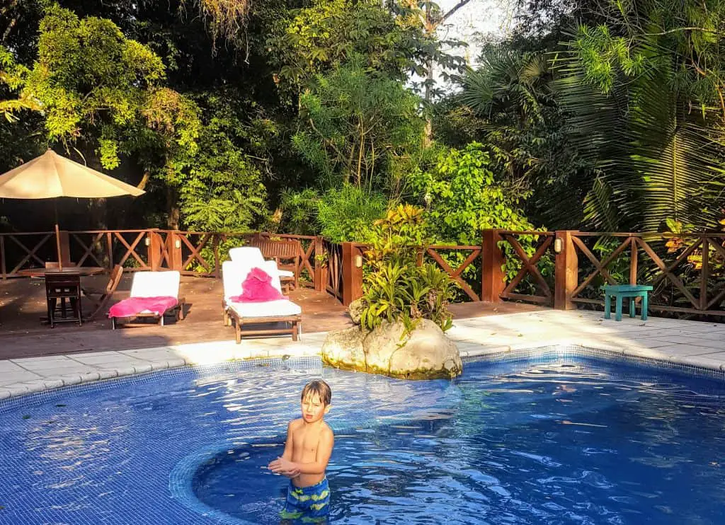 Boy in the pool at the Jungle Lodge in Tikal National Park Guatemala