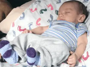 Infant sleeping on a blanket