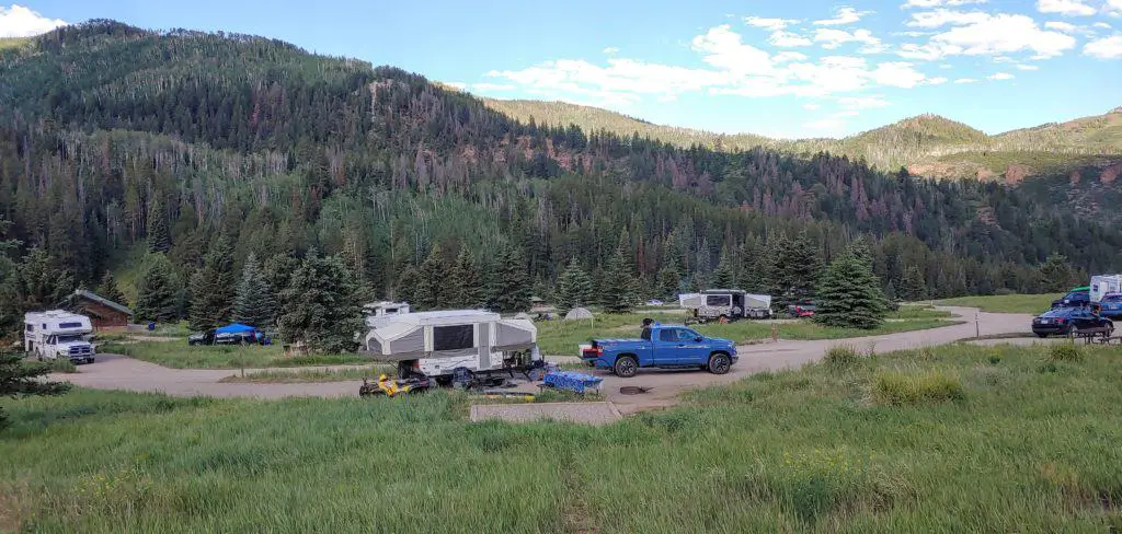 campground full of campers with the mountains in the background