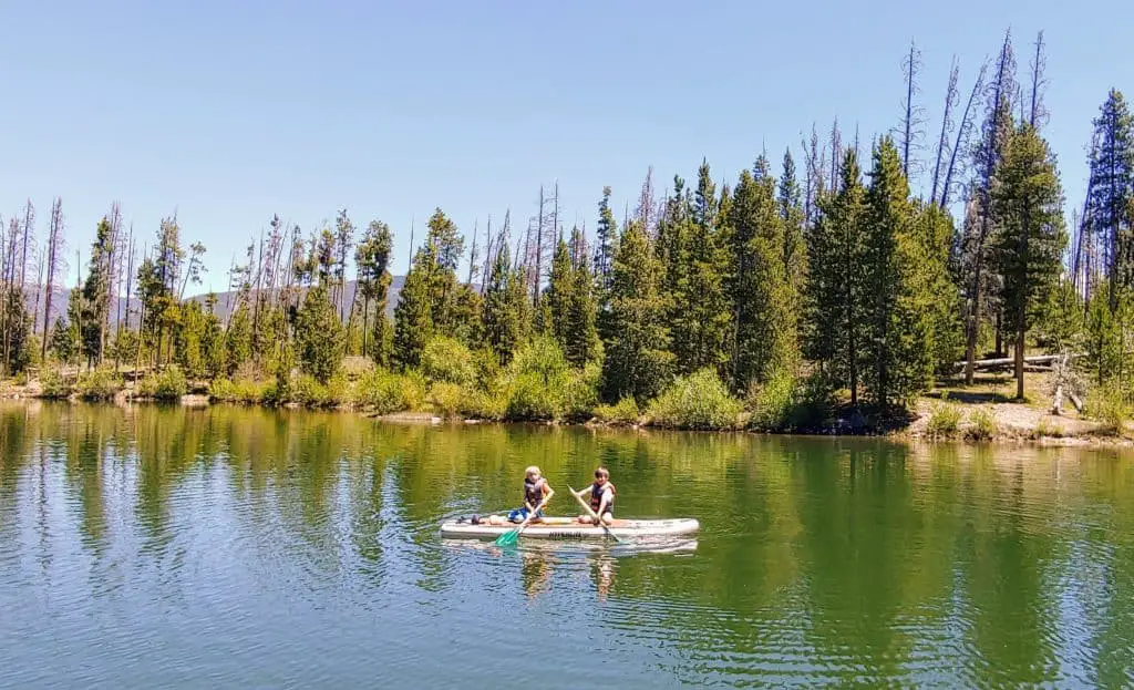 Two boys on a paddle board in Lake Dillon