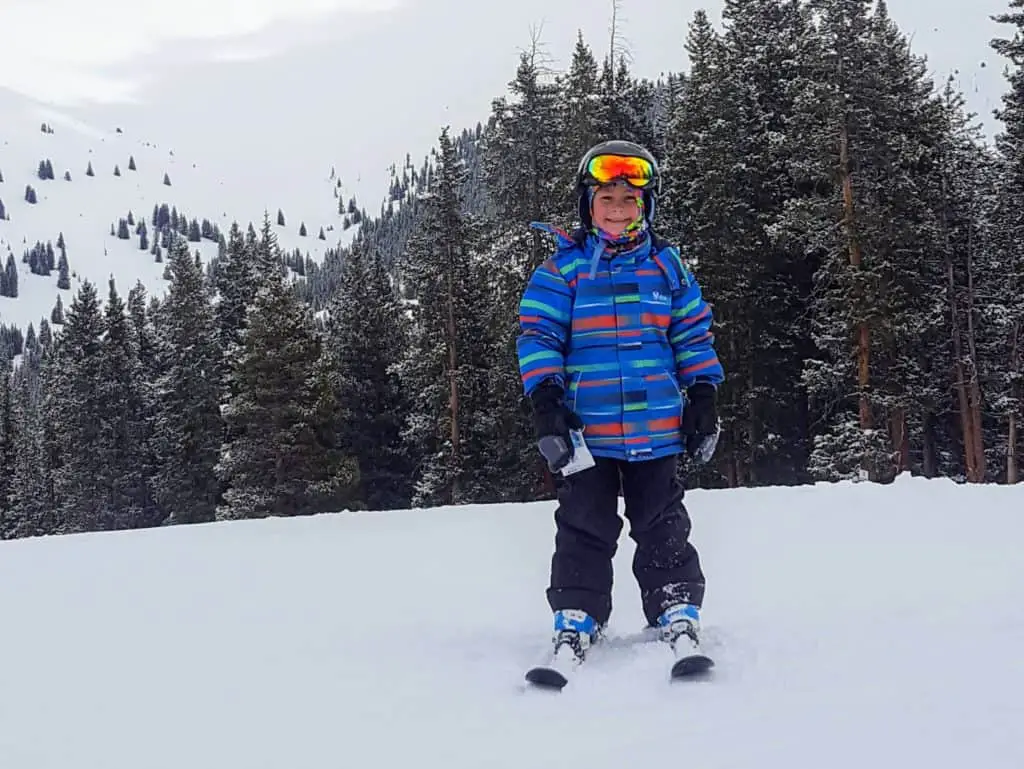 boy standing on skis at a ski resort in Colorado