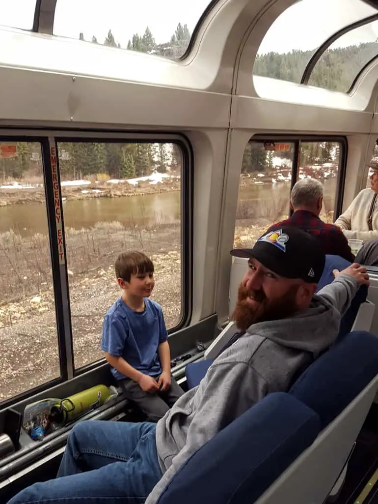 Father and son in the view car of the Amtrak California Zephyr through Colorado