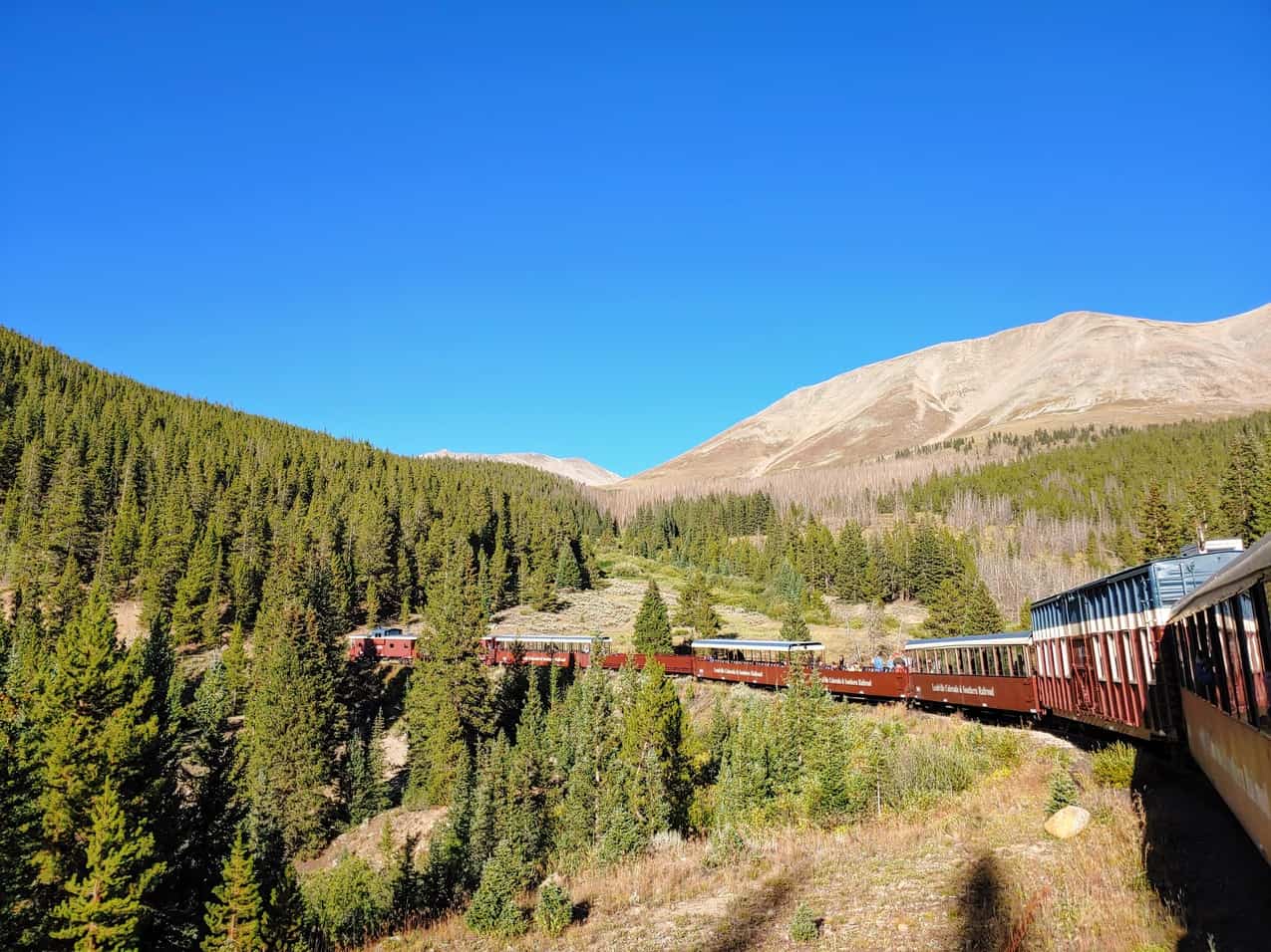 Leadville train on the tracks headed through a high mountain pass