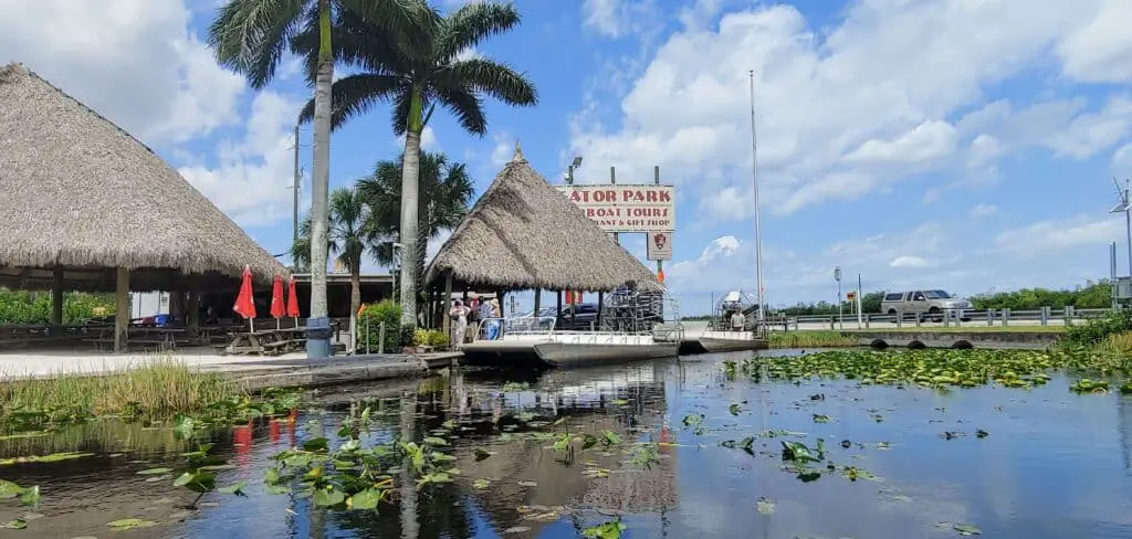 Airboat, sign, and dock at Gator Park Airboat Tours