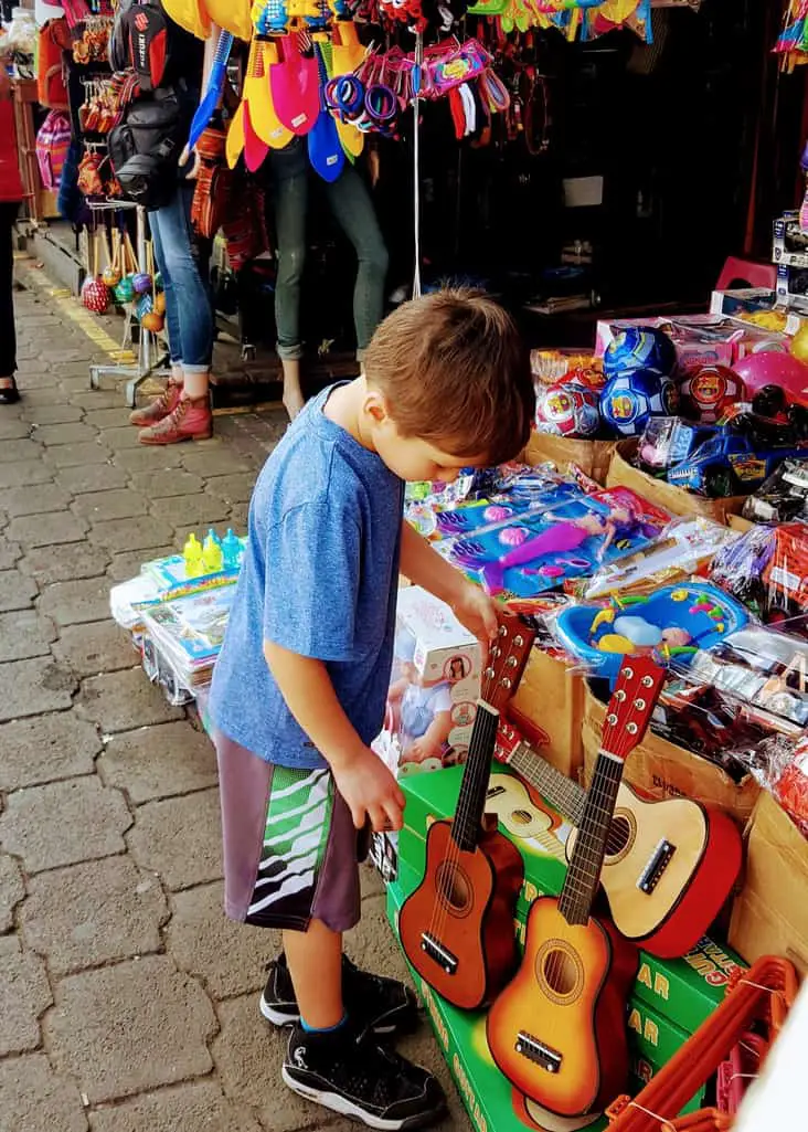Boy looking at a table full of souvenirs 