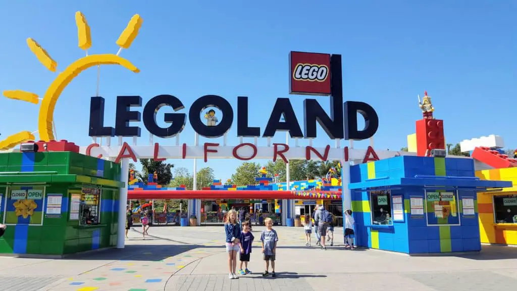Kids standing in front of the Legoland California entrance