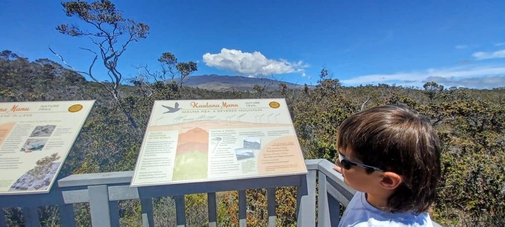 boy in front of a sign along Kaulana Nature Trail Big  Island Hawaii