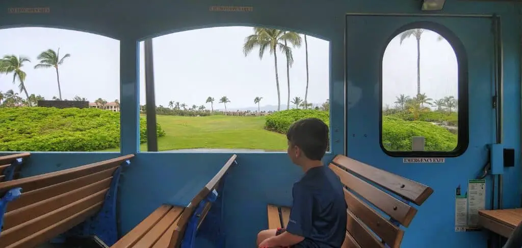boy riding the trolley in Waikoloa Hawaii