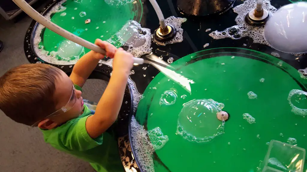 boy playing with bubbles at the Children's Museum in Denver Colorado