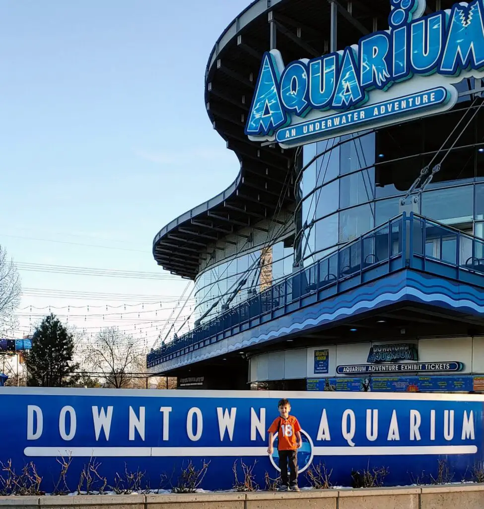 boy standing in front of the Downtown Denver Aquarium