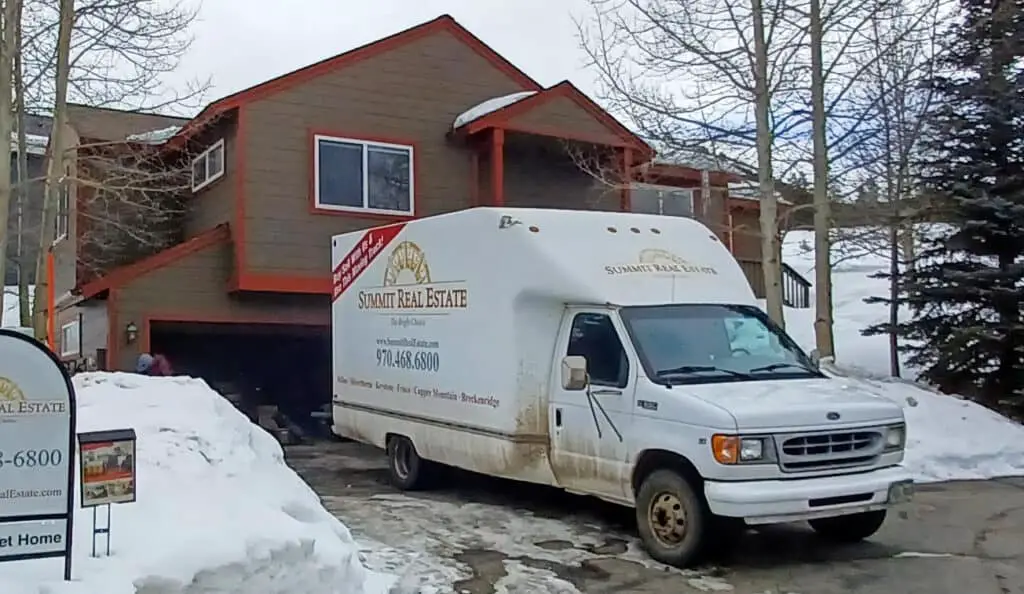 moving van in front of a house in Colorado in the winter