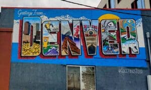 Sign painted on the side of a building that says DENVER