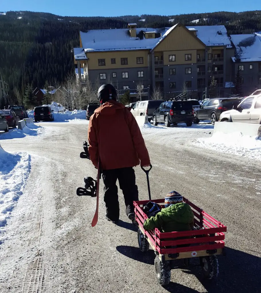 dad pulling his son in a wagon at Keystone Ski resort