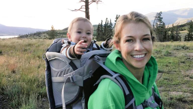 Toddler on mom's back in a backpack carrier