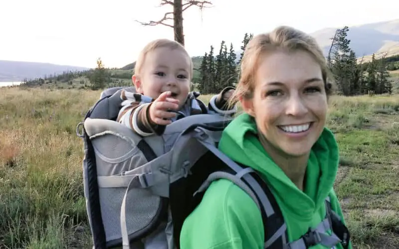 Toddler on mom's back in a backpack carrier