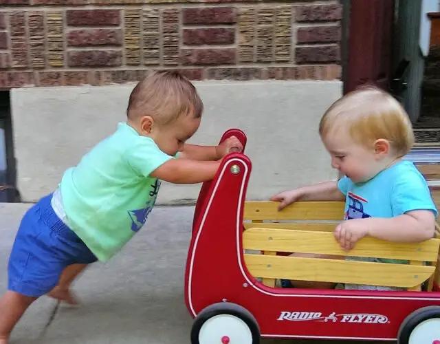 Toddler pushing another toddler in a wagon - Best Stroller Alternatives for toddlers