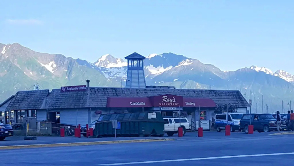 Ray's Waterfront Restaurant with rugged mountains in the background in Seward, Alaska