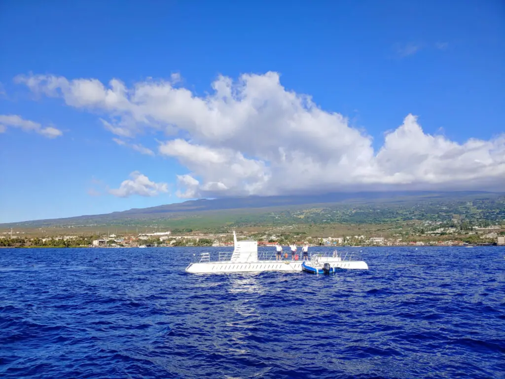 The Atlantis Kona Submarine above water on a sunny day in the ocean just off the shores of Kona, Hawaii