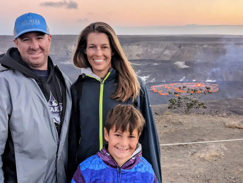 Family in front of an erupting crater in Hawaii Volcanoes National Park