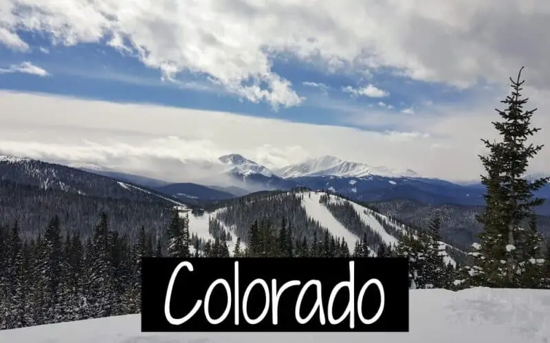 The word Colorado on a picture of Colorado mountains in the winter