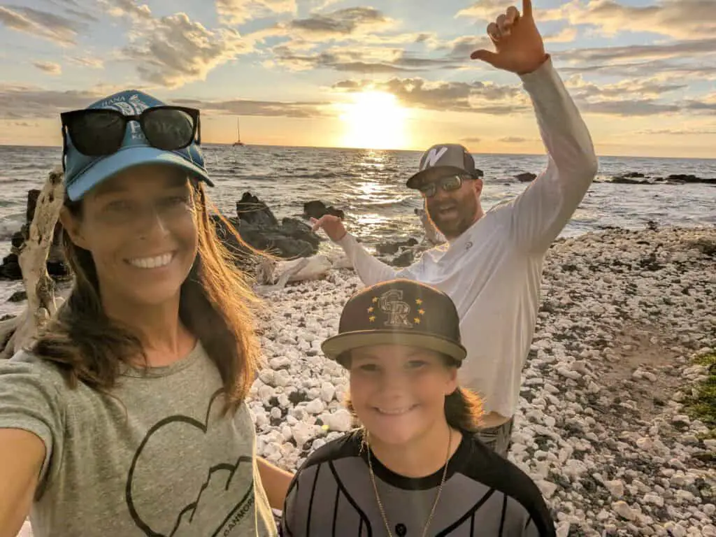 Happy family on the beach at sunset